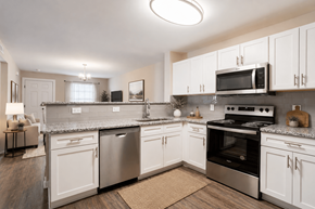 Salisbury apartment for rent - A kitchen with white cabinets and stainless steel appliances.