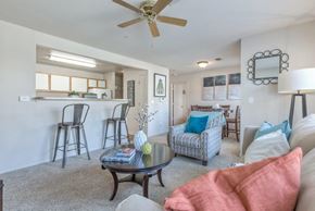 Owasso apartment for rent - A living room with a couch, chairs, and a coffee table.
