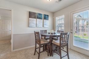 Owasso apartment for rent - A dining room with a table and chairs.