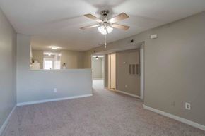 Rock Hill apartment for rent - A spacious room with a ceiling fan and carpeted floor.