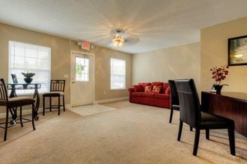 Salisbury apartment for rent - A living room with a red couch and a wooden table.