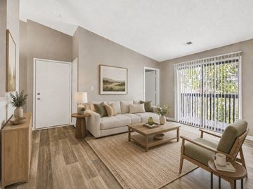 Georgetown apartment for rent - A living room with a white couch, a wooden coffee table, and a painting on the wall.