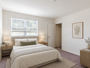 Claymont apartment for rent - A bedroom with a large bed and a painting on the wall.