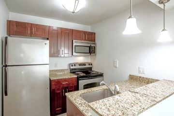 West Palm Beach apartment for rent - A kitchen with granite countertops and stainless steel appliances.