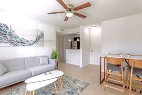 West Palm Beach apartment for rent - A living room with a grey couch, a white coffee table, and a ceiling fan.