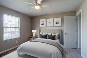 Salisbury apartment for rent - A bedroom with a large bed and a ceiling fan.