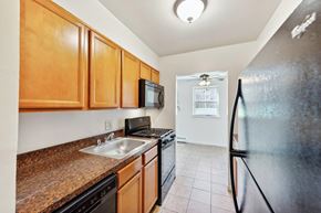 Reading apartment for rent - a kitchen with stainless steel appliances and wooden cabinets