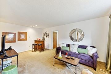 Reading apartment for rent - A living room with a purple couch and a wooden coffee table.