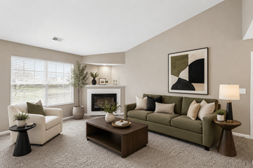 Centerville apartment for rent - A living room with a fireplace, two chairs, a couch, and a painting on the wall.