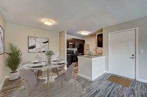 Broken Arrow apartment for rent - A dining area with a table set for six with chairs around it.