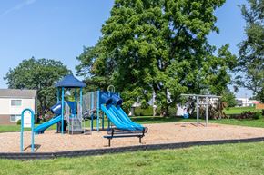 Quakertown apartment for rent - A playground with a blue slide and a bench.