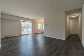 Horsham apartment for rent - A spacious room with wooden floors and white walls.