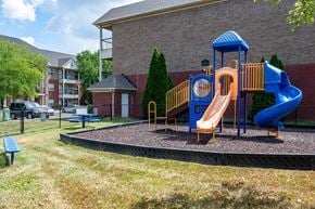 Louisville apartment for rent - A playground with a blue slide and yellow structure.