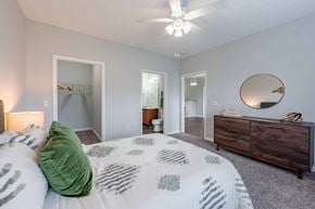Louisville apartment for rent - A bedroom with a bed, dresser, and mirror.
