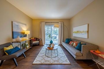Columbus townhouse for rent - A living room with a grey couch, a coffee table, and a painting on the wall.