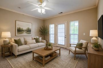 Mebane apartment for rent - A living room with a couch, a chair, a coffee table, and a painting on the wall.