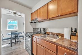 Carlisle apartment for rent - a kitchen with wooden cabinets and a sink and a stove