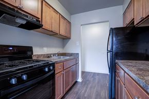 Carlisle apartment for rent - A kitchen with a black stove and refrigerator.