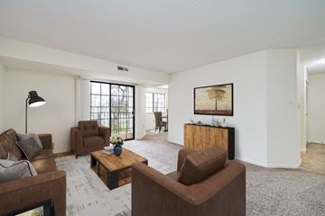 Cincinnati apartment for rent - A living room with brown furniture and a painting on the wall.