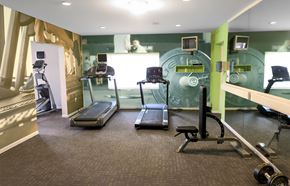 Cincinnati apartment for rent - A gym with treadmills, exercise bikes, and weights.