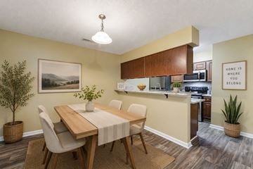Fayetteville apartment for rent - A dining room with a wooden table and chairs.