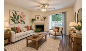 Fayetteville apartment for rent - A living room with a couch, chair, and a fireplace.