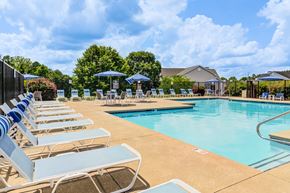 Fayetteville apartment for rent - A pool with sun loungers and umbrellas.