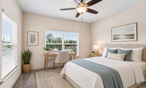 Jacksonville apartment for rent - A bedroom with a bed, desk, and chair.