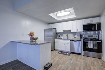 Hilliard apartment for rent - A kitchen with white cabinets and a granite countertop.