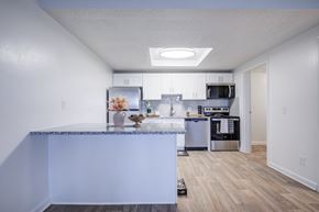 Gainesville apartment for rent - A kitchen with a marble countertop and stainless steel appliances.