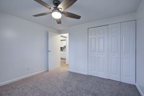 Ocala townhouse for rent - A room with a ceiling fan and carpeted floor.