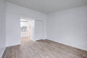 Smyrna apartment for rent - A room with a wooden floor and white walls.