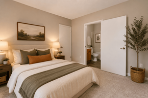 Clemmons apartment for rent - A bedroom with a large bed and a painting on the wall.