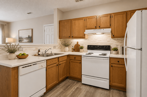 Clemmons apartment for rent - A kitchen with wooden cabinets and white appliances.