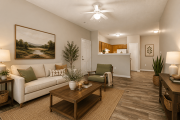 Clemmons apartment for rent - A living room with a white couch and a painting on the wall.