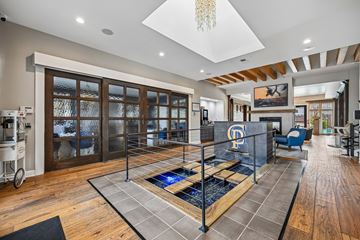 New Albany apartment for rent - A modern living room with a pool table in the center.