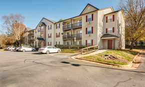 Concord apartment for rent - an apartment building with cars parked in a parking lot