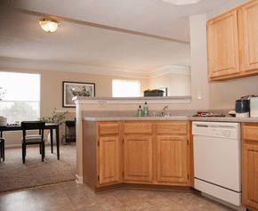 Memphis apartment for rent - A kitchen with wooden cabinets and a white dishwasher.