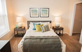 Memphis apartment for rent - A bedroom with a large bed and two nightstands with lamps.