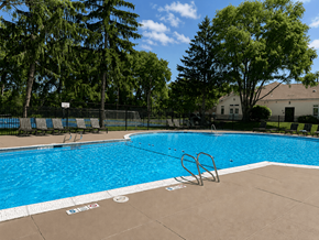 Webster apartment for rent - A swimming pool surrounded by trees and a fence.