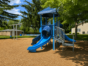 Webster apartment for rent - A playground with a blue slide and a blue roofed structure.