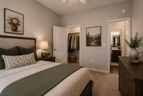 Columbia apartment for rent - A bedroom with a large bed and a painting on the wall.