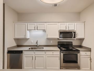 Lancaster townhouse for rent - A kitchen with white cabinets and stainless steel appliances.