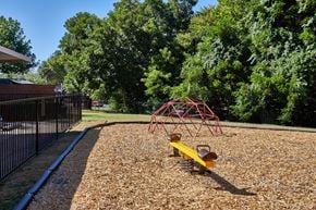 Lancaster townhouse for rent - A playground with a red swing set and a yellow slide.
