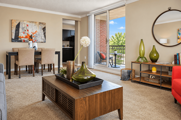 Louisville apartment for rent - A living room with a brown coffee table and a painting on the wall.