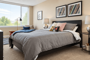 Louisville apartment for rent - A bedroom with a large bed and two framed pictures on the wall.