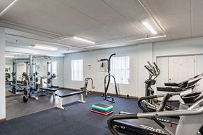 Cincinnati apartment for rent - A gym with a variety of equipment including treadmills, weights, and exercise machines.