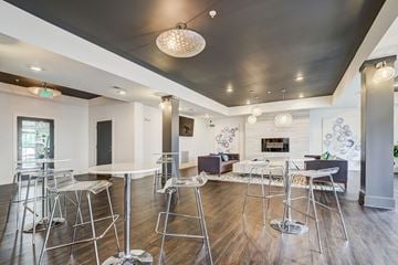 Columbia apartment for rent - a communal space with tables and chairs and a living room with a fireplace