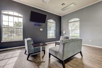 West Palm Beach apartment for rent - a living room with couches and a table and a television