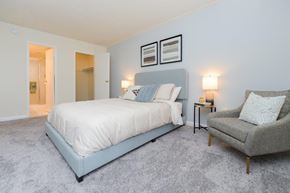 Jeffersonville apartment for rent - a blue and white bedroom with a bed and a chair